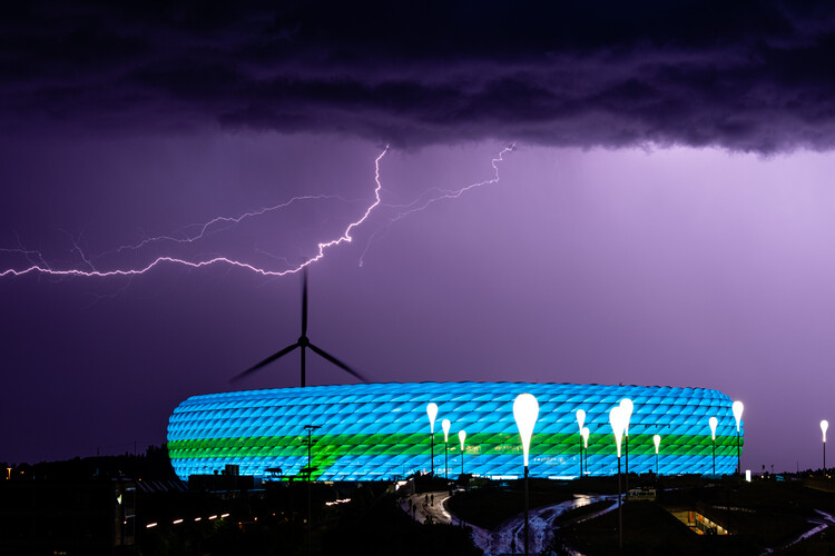 Lightnings above the blue and green illuminated stadium during the Euro 2020 soccer championship group F match between Germany and Hungary in Munich, Germany, Wednesday, June 23, 2021. The UEFA didn't allow Munich to illuminate the stadium for this evening’s Euro2020 match in rainbow colors in a show of support for LGBT people.The decision by European soccer’s governing body was widely criticized in Germany, which plays Hungary in the final group match in Munich. (AP Photo/Florian Schroetter)